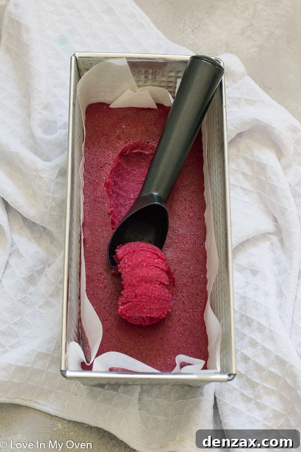 Scoops of cranberry sorbet in a loaf pan, ready to be served.