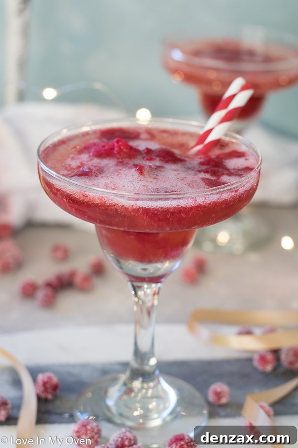 Two Cranberry Sorbet Champagne Floats, one with a focus on the cranberries at the bottom.