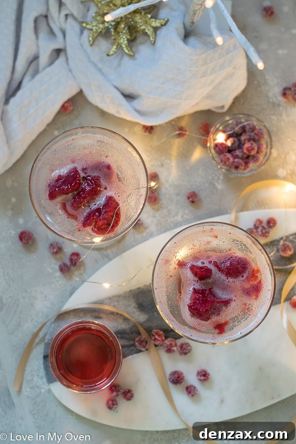 Close-up of a Cranberry Sorbet Champagne Float with a spoon, highlighting the sorbet texture.