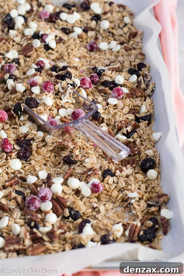 Hand scooping cranberry pecan granola