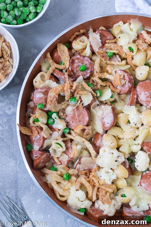 A serving of the Veggie and Sausage Pasta Skillet in a bowl, garnished with crispy onions and black pepper, ready to be enjoyed as a hearty and quick family meal