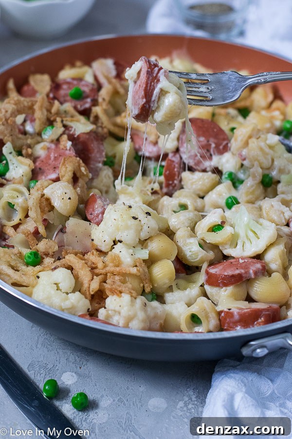 A vibrant aerial shot of the Veggie and Sausage Pasta Skillet in a skillet, garnished with fresh parsley, emphasizing its visual appeal and deliciousness