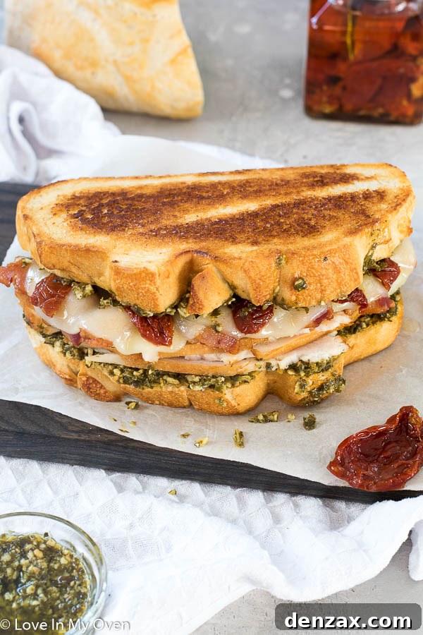 Delicious and easy-to-make Turkey Pesto Sandwich with provolone and sundried tomatoes