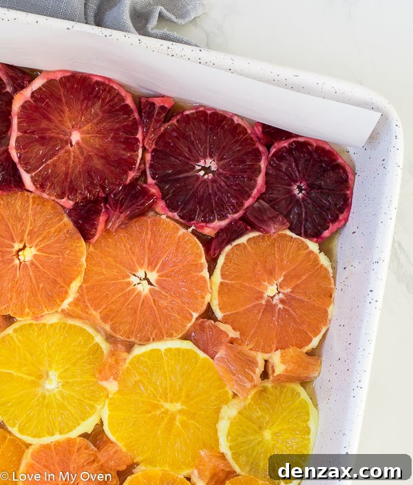 Orange slices arranged in a baking pan, with smaller pieces filling in the gaps for a cohesive design.