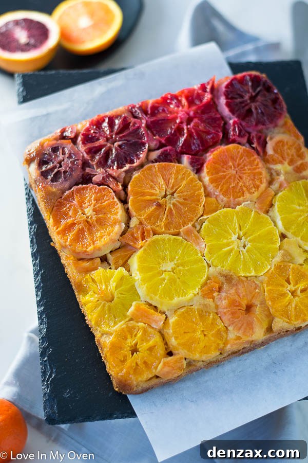 A stunning slice of orange upside down cake, showcasing the moist interior and caramelized citrus topping.