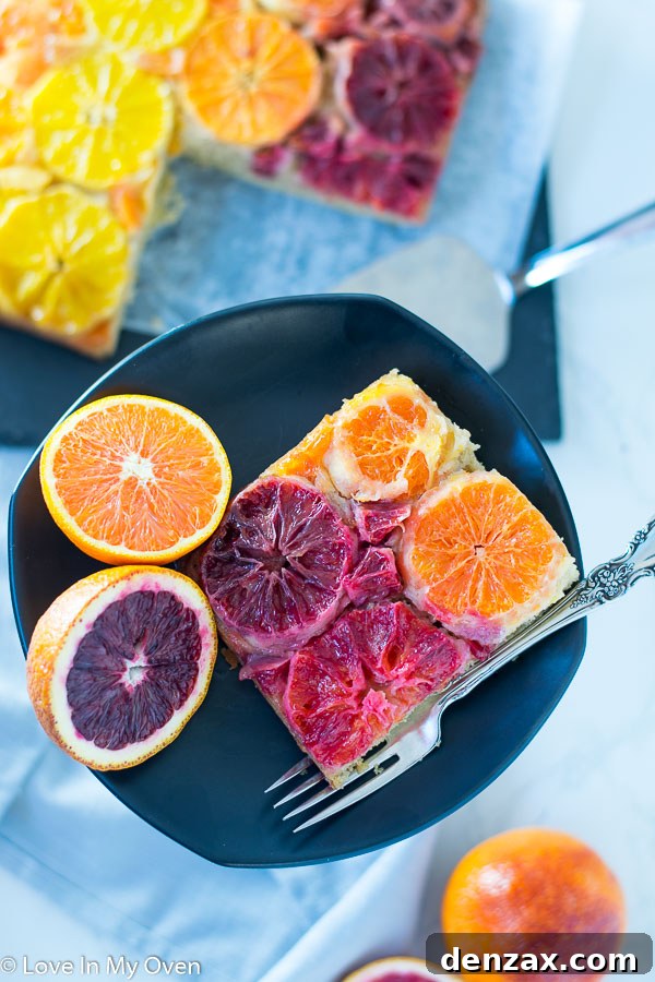 Close-up view of the golden-brown, sticky glaze and perfectly arranged citrus slices on an orange upside down cake.
