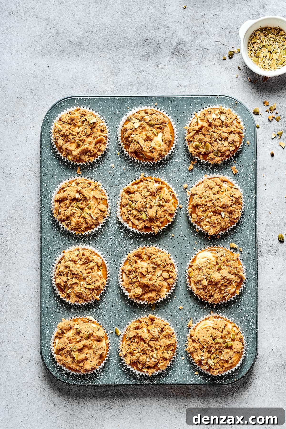 Pumpkin cream cheese muffins in a tin.