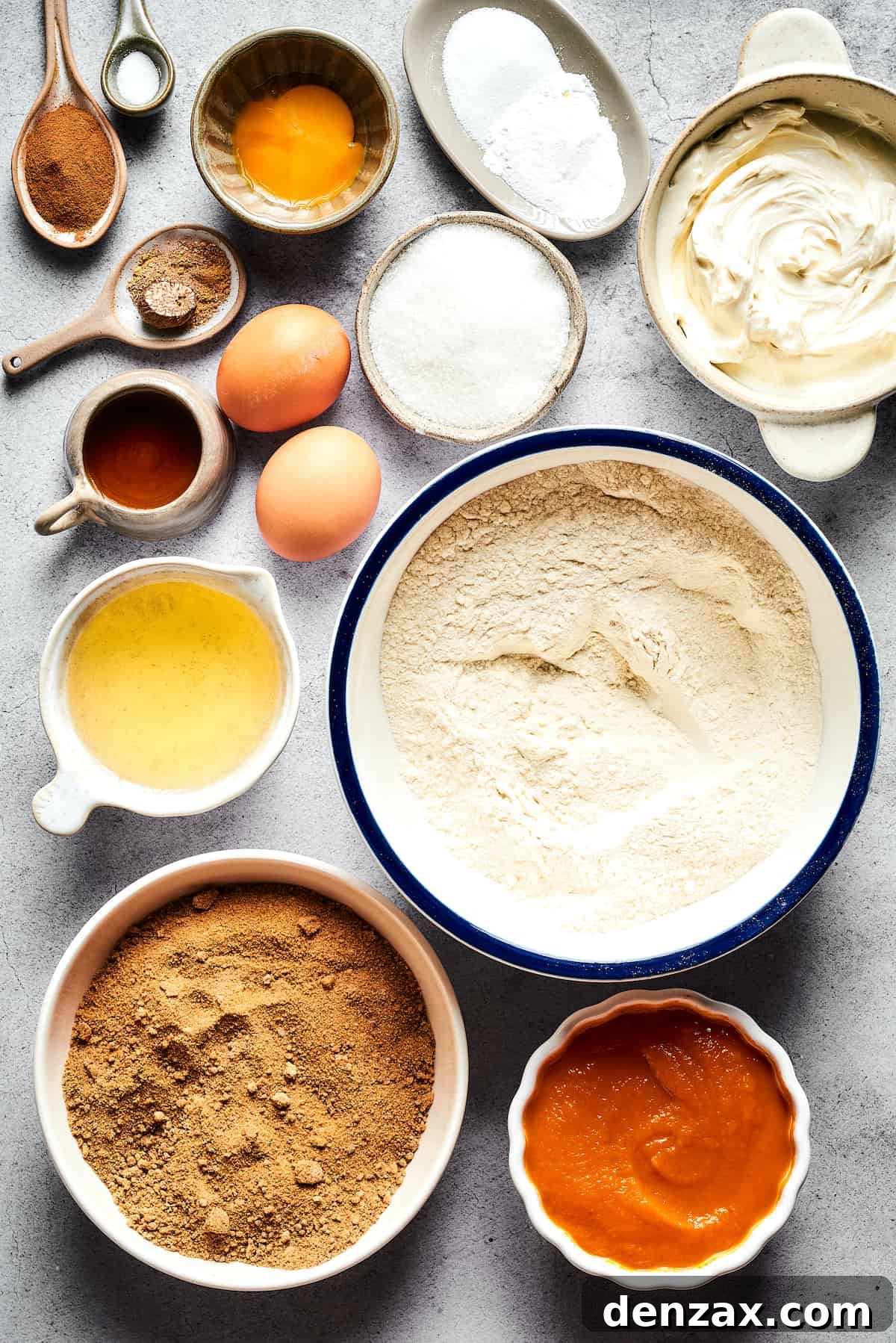 From top: Cinnamon, salt, eggs and an egg yolk, baking powder and baking soda, cream cheese, white sugar, vegetable oil, flour, brown sugar, pumpkin puree.