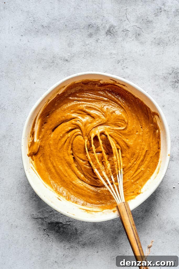 Pumpkin muffin batter in a mixing bowl.
