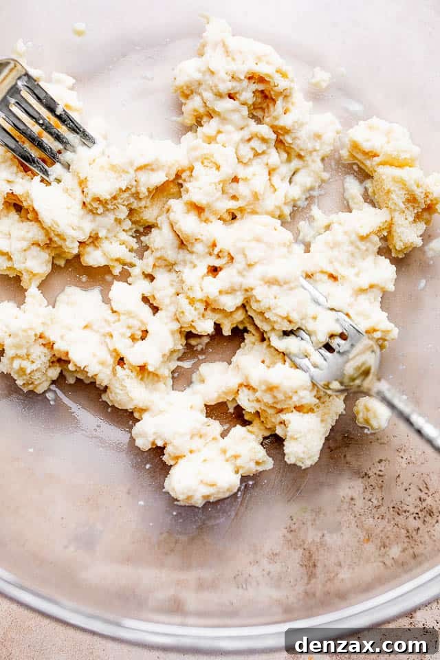 These homemade Swedish meatballs are bite-sized balls of beef and pork smothered in a rich, creamy gravy. A comforting and belly warming meal! Shredded bread slices soaking in milk in a glass bowl, preparing them for the meatball mixture.