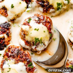 A close-up of delicious homemade Swedish meatballs drizzled with creamy brown gravy, ready to be served.