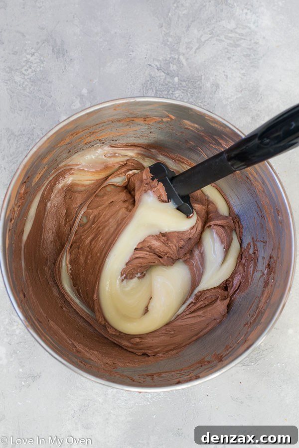 Chocolate vegan ice cream mixture being smoothed into a loaf pan for freezing
