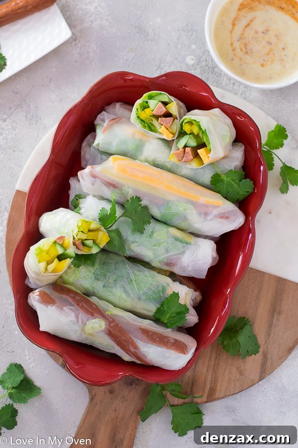 Assortment of turkey pepperoni salad rolls with a small bowl of honey mustard dipping sauce, ready to be served.