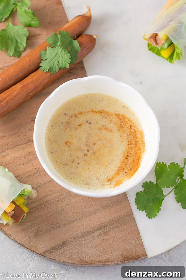 Small bowl of homemade honey mustard dipping sauce, creamy and golden, ready for serving.