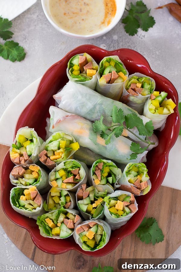 Arrangement of turkey pepperoni salad rolls and a small bowl of honey mustard dip on a rustic background.