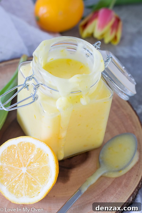 A spoonful of homemade Meyer lemon curd, showing its creamy texture and vibrant color.