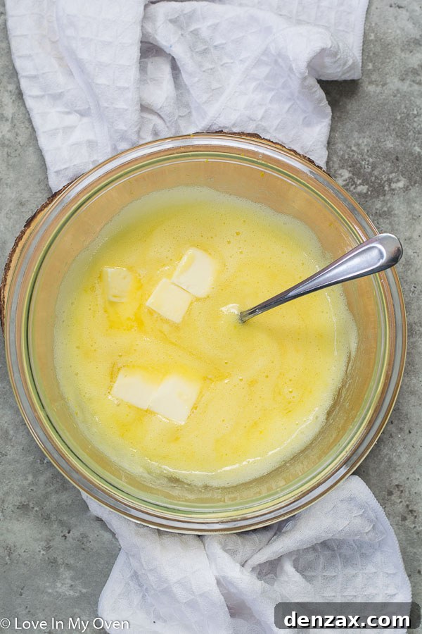 Meyer lemon curd cooking in a double boiler, showing the thickening process.