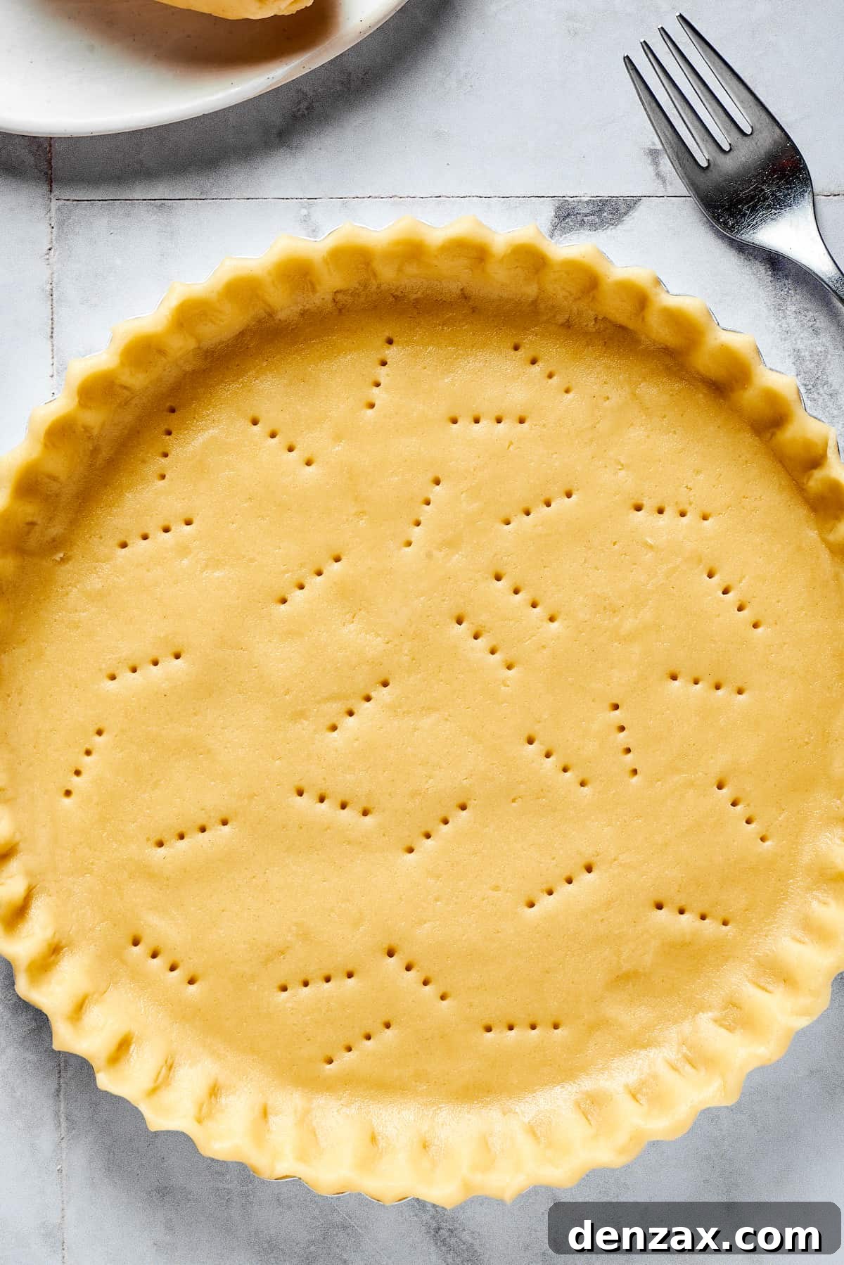 A perfectly golden-brown, baked homemade pie crust, showcasing its inviting flaky texture.