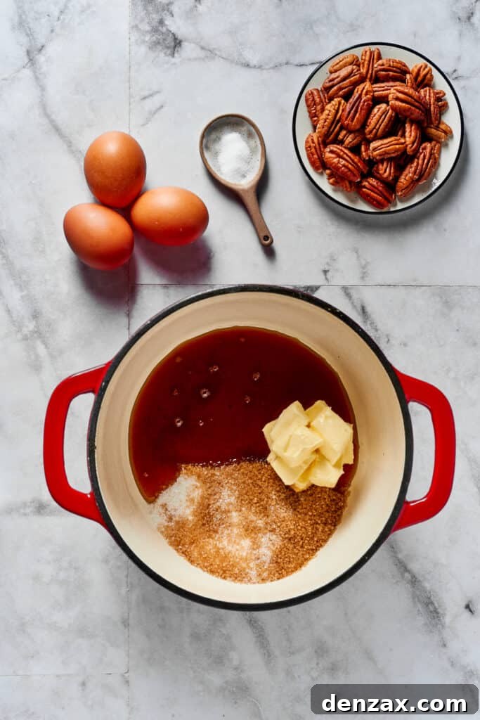 Irresistible Pecan Pie 2 A heavy pot on a stovetop with butter, sugar, and syrup inside, ready to be melted and combined. Eggs, salt, and pecans are artfully arranged in small dishes on the work surface, highlighting the key ingredients for the pecan pie.