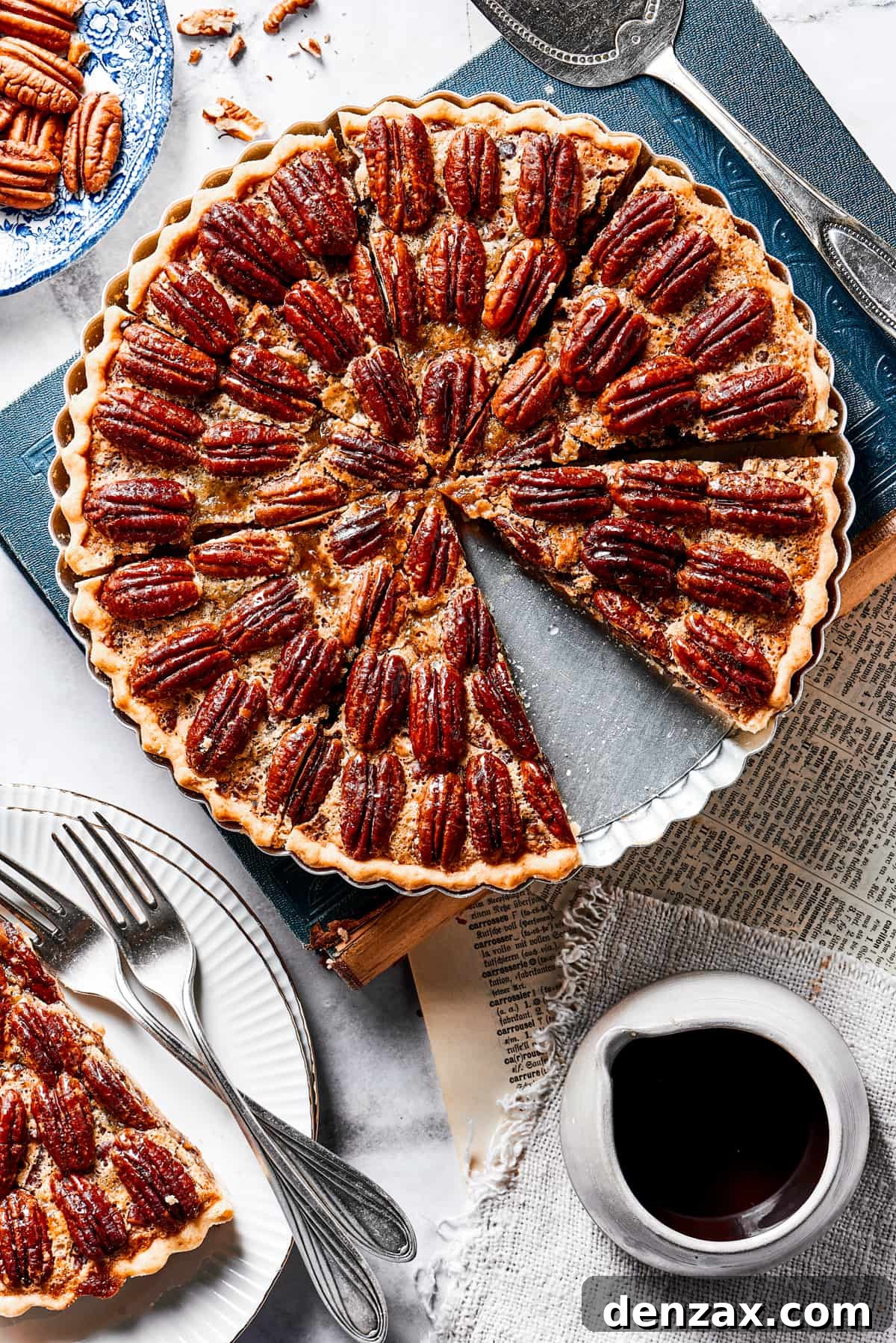 The Best Pecan Pie Recipe is here, easy to make and perfect for your holiday table! You'll love the homemade crust and sweet, nutty filling. A beautiful slice of pecan pie on a small serving dish, positioned next to the rest of the pie in its dish, inviting you to enjoy.
