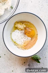 A bowl containing the creamy yogurt and spice mixture for chicken tenders.