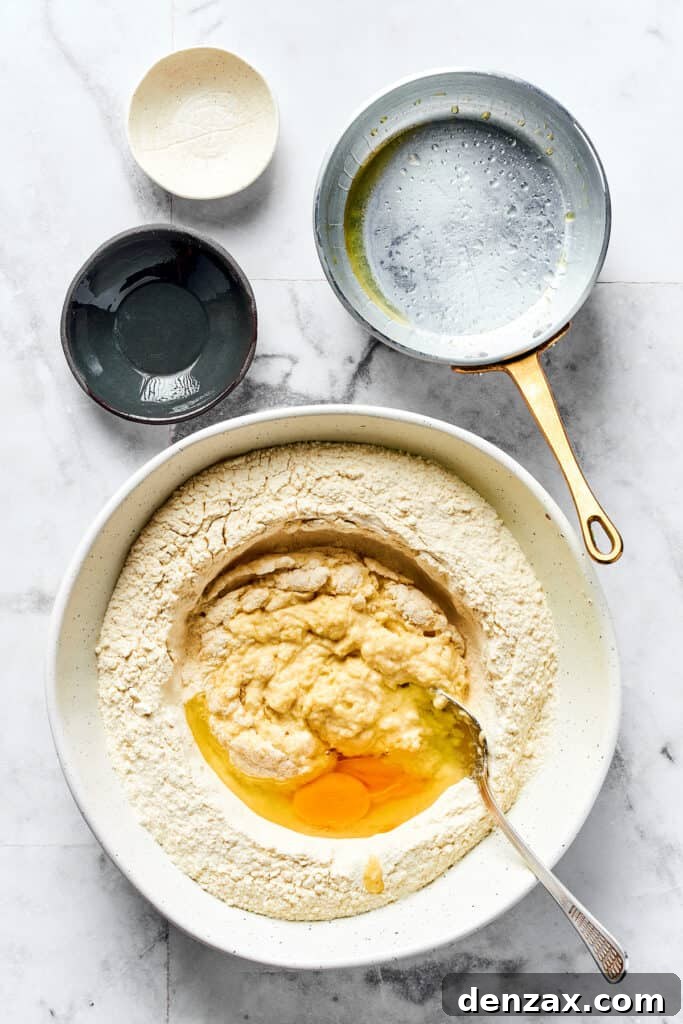 Pierogi dough ingredients in a bowl, with a fork for mixing.