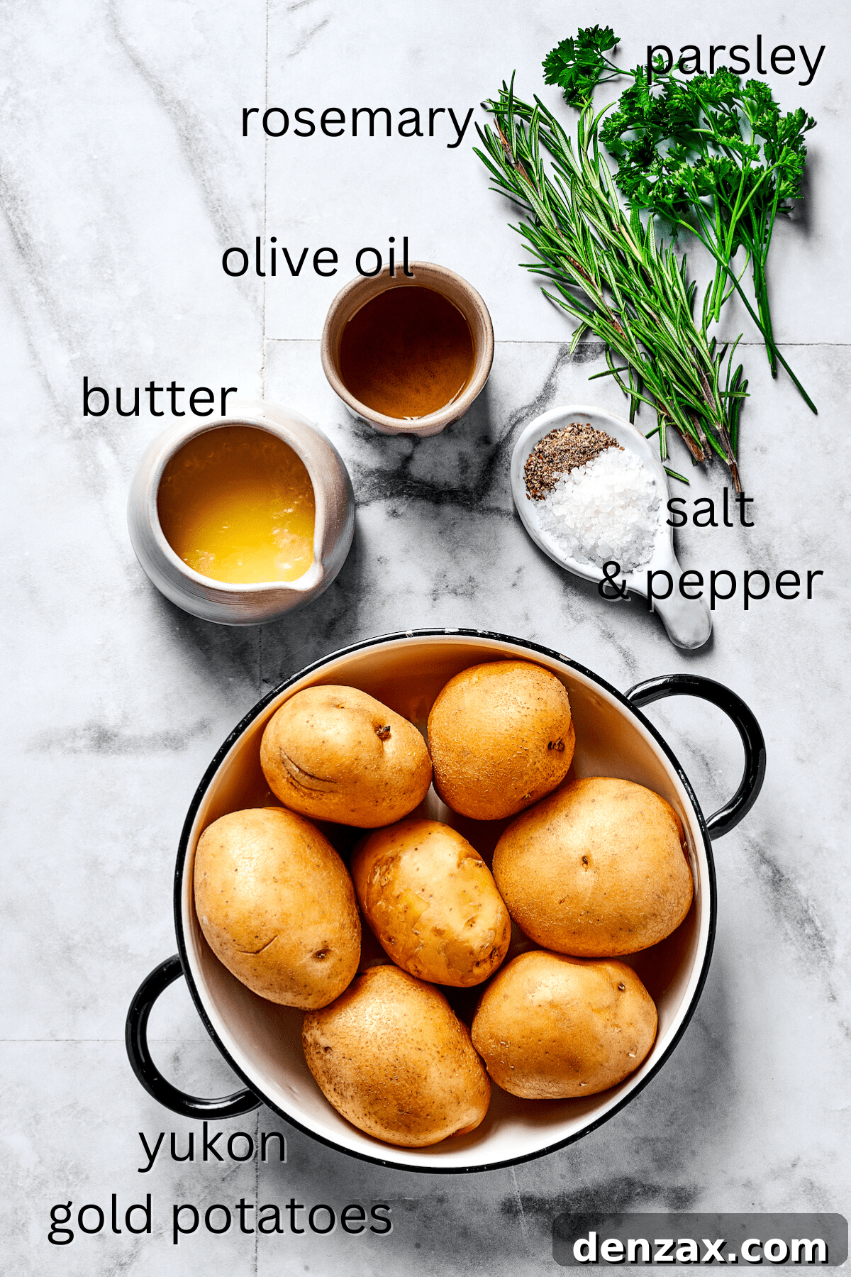 From top: Fresh herbs, olive oil, melted butter, salt and pepper, and chopped raw potatoes arranged for ingredients shot.