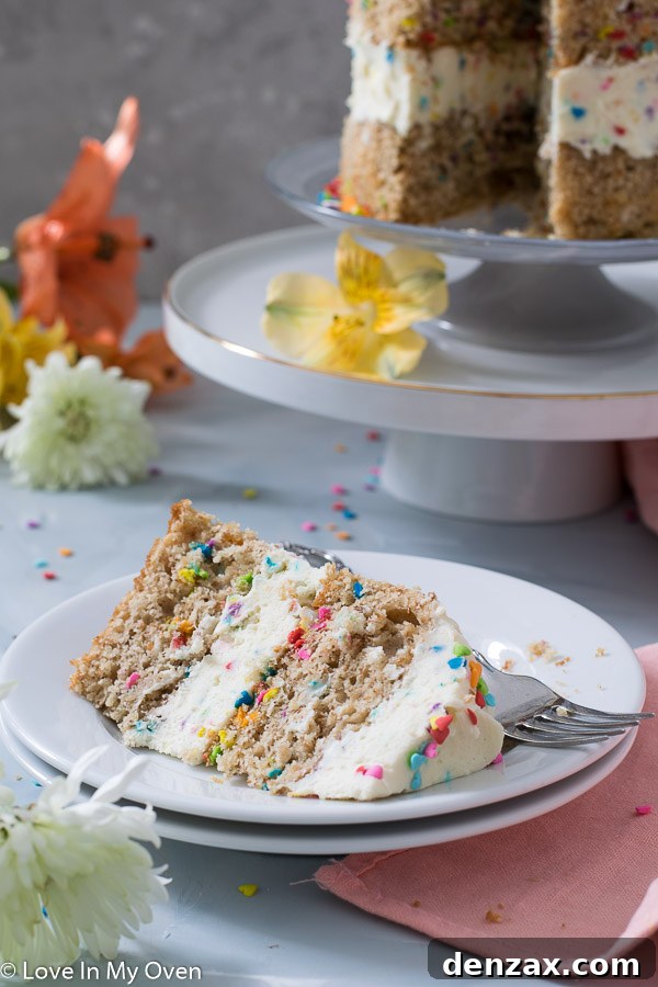 A close-up of the healthy birthday cake, showing a moist interior and colourful sprinkles on top of the creamy frosting.