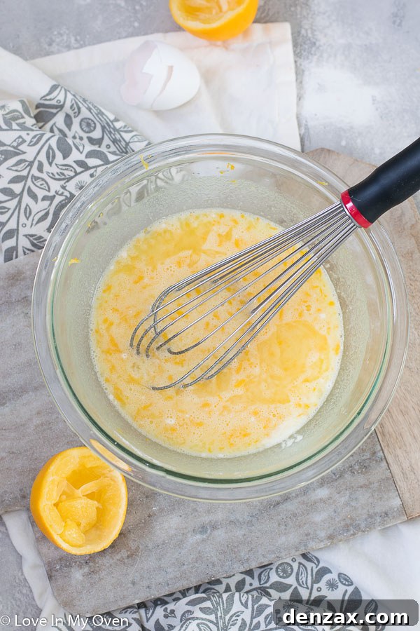 Mixing bowl with Meyer lemon bar filling ingredients: eggs, sugar, lemon juice and zest, flour, and baking powder.