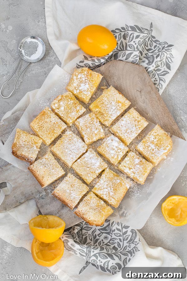 Meyer Lemon Bars cooling on a wire rack, ready for dusting with powdered sugar and slicing.