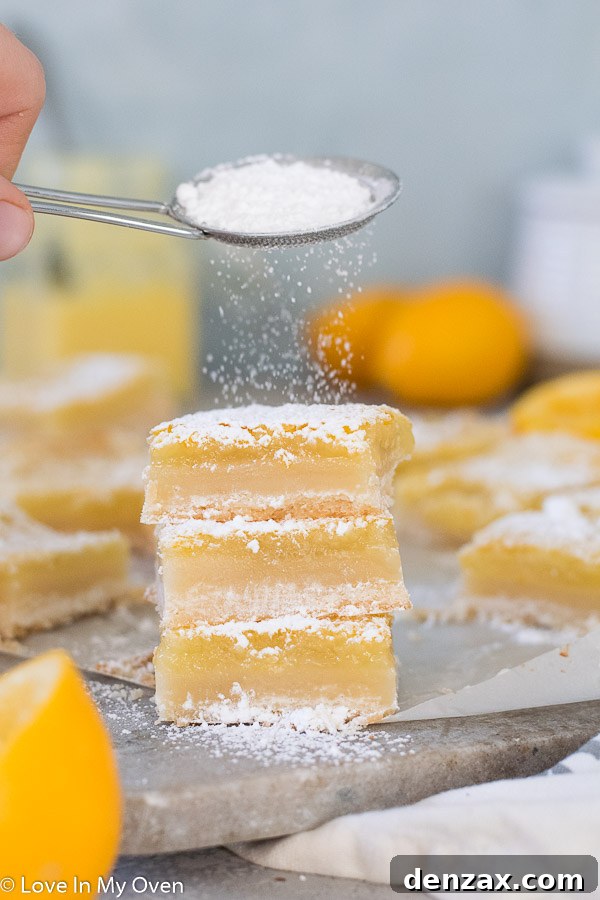 A stack of delightful Meyer Lemon Bars, showing their thick lemon filling and crumbly shortbread base.
