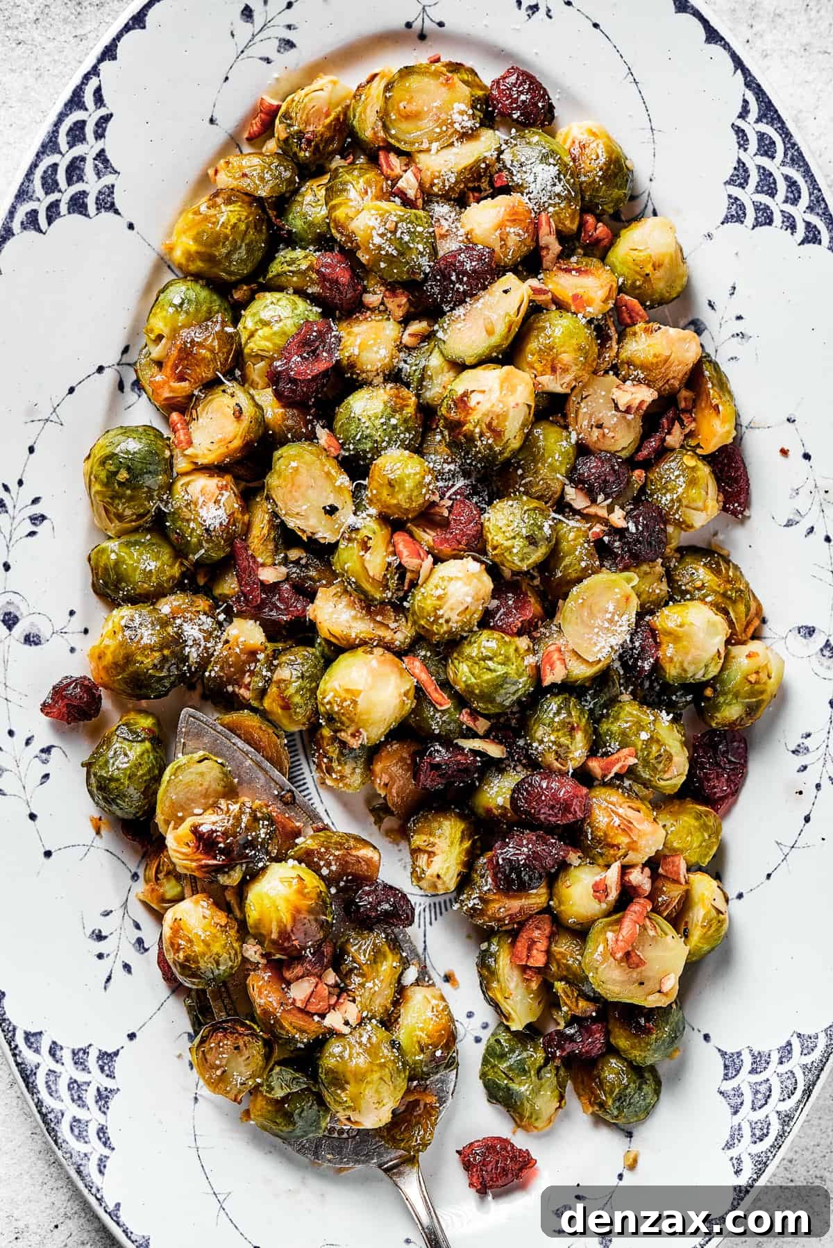 Close-up of the perfectly glazed and garnished roasted Brussels sprouts, showcasing their inviting texture and color.