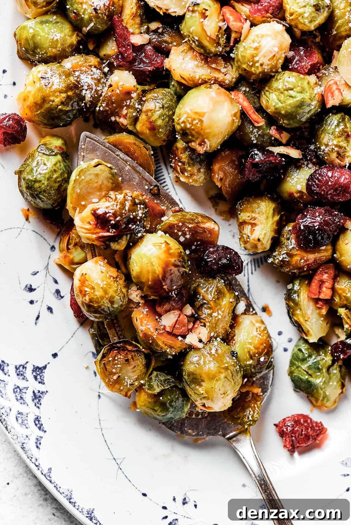 A vibrant serving platter generously loaded with glossy, roasted Brussels sprouts, ready to be enjoyed.