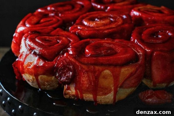 Warm Sourdough Plum Cinnamon Rolls, glazed and ready to enjoy.
