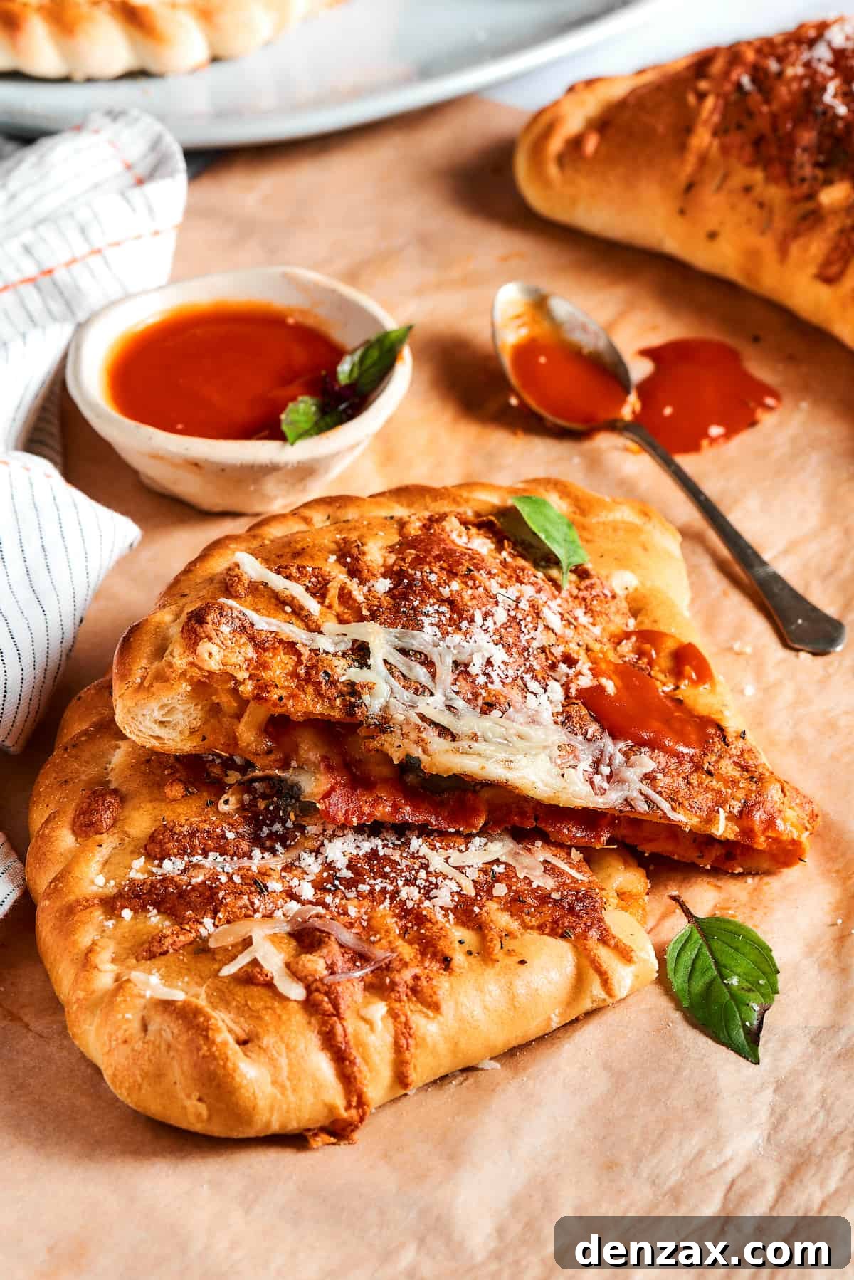 A pizza pocket cut in half to show the cheesy filling.