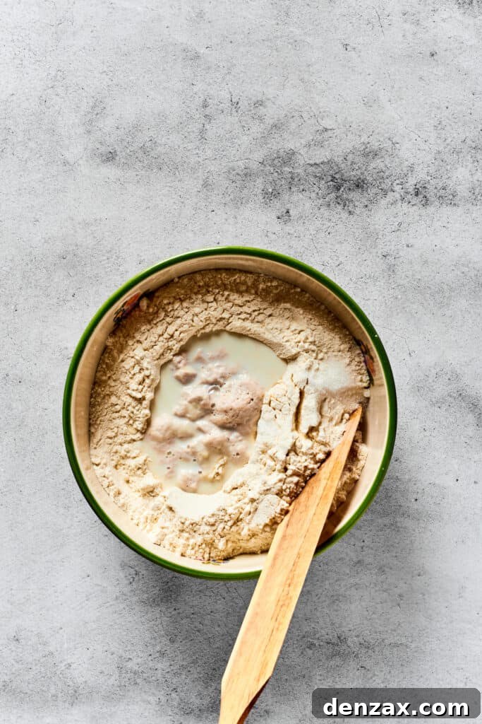MIxing together calzone dough in a mixing bowl.