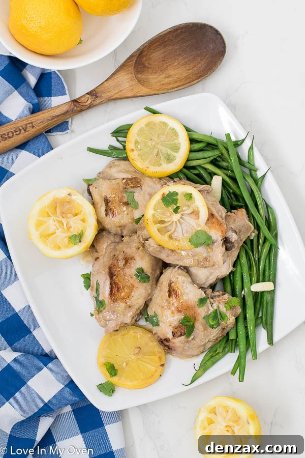 Close-up of Instant Pot Lemon Garlic Chicken Thighs with creamy sauce.