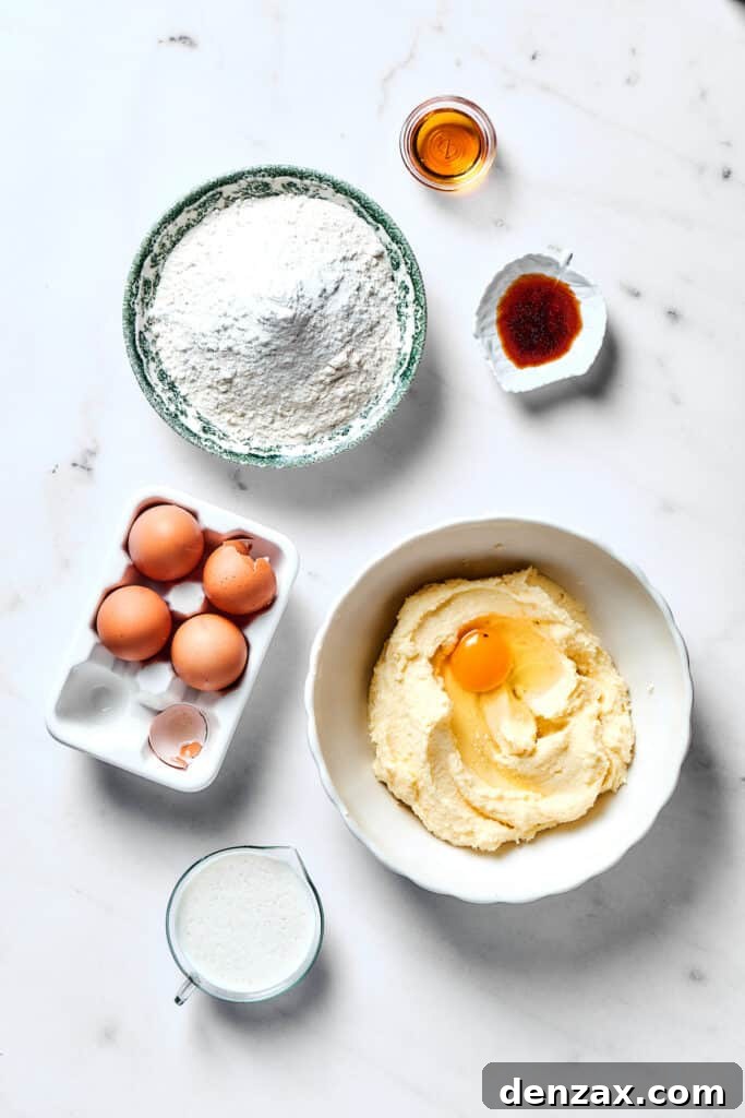 Adding eggs one by one to the creamy butter and sugar mixture in a stand mixer.