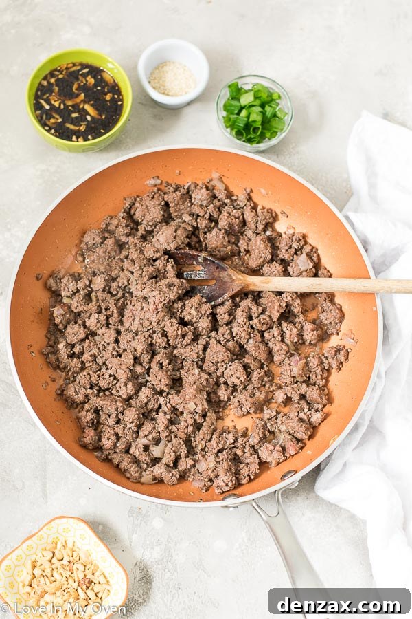 Mixing hoisin sauce with cooked ground beef
