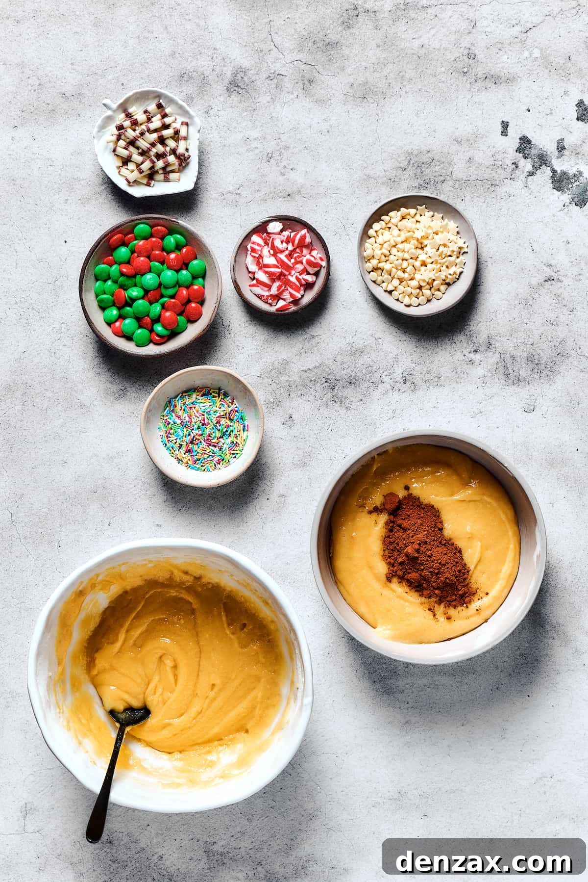 The process of adding cocoa powder to one portion of cookie dough in a mixing bowl, creating a rich chocolate flavor for half the batch.