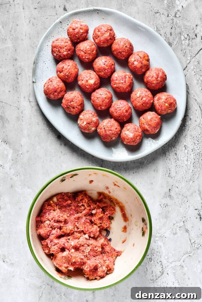 A bowl of meatloaf mixture next to a platter of shaped meatballs.