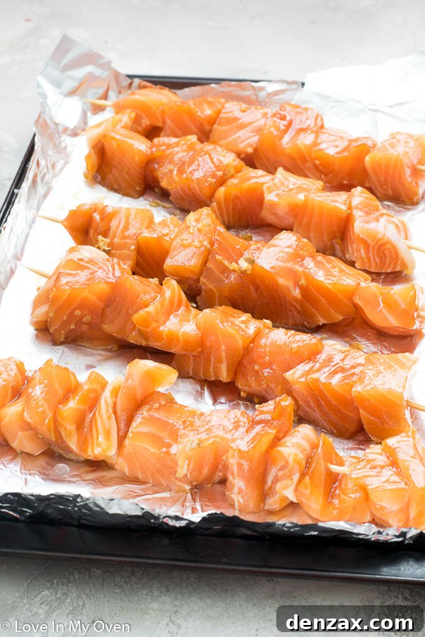 Teriyaki salmon threaded onto wooden skewers