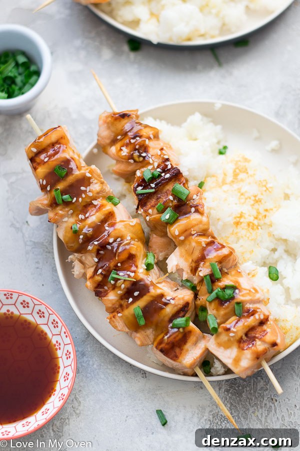Grilled teriyaki salmon bites on a plate with sauce