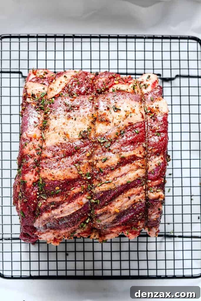 Setting a tied rib roast on a roasting rack.