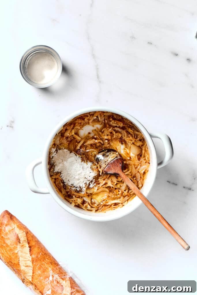 Cooking French Onion Soup with flour and seasoning added to the onions.