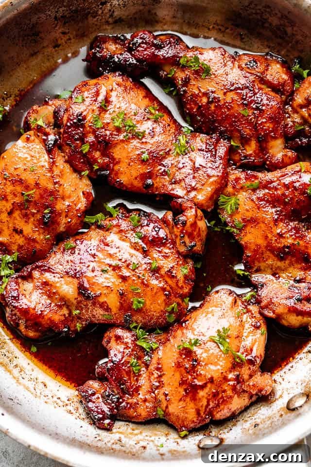 cooking chicken thighs in a skillet, showcasing a beautiful sear and rich color