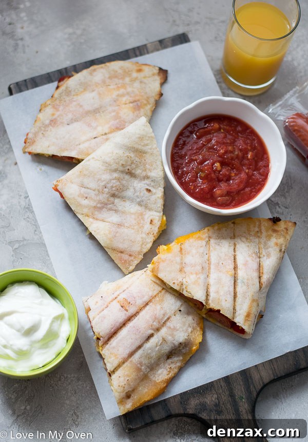 Serving grilled breakfast quesadillas with dipping sauces.