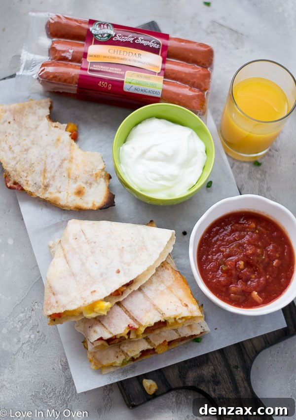 Close-up of a cut grilled breakfast quesadilla revealing the cheesy filling.