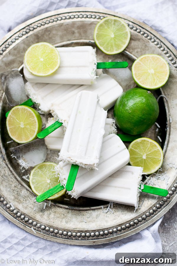 Close-up of vibrant coconut lime popsicles, showing their creamy texture and inviting green hue.