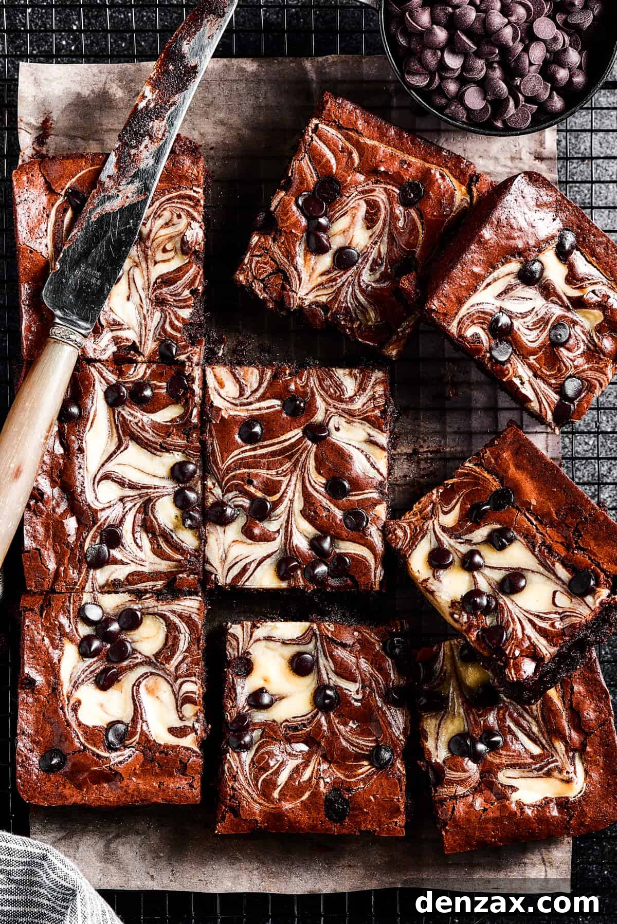 Perfect fudgy brownies get a major upgrade in this Cream Cheese Brownies recipe! An easy dessert loaded with cheesecake and chocolate. Baked cream cheese brownies with a distinct swirl pattern and chocolate chips.